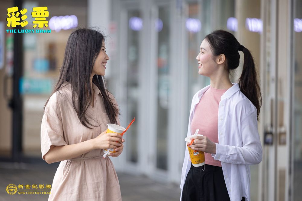 Still from The Lucky Draw: two young women chatting and smiling